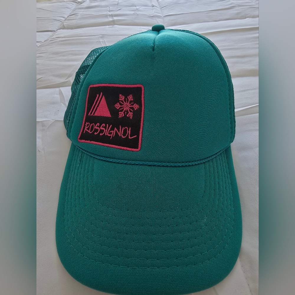 Rossignol Vintage Style teal trucker hat with a pink logo patch